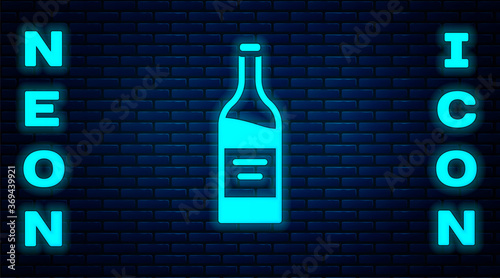 Glowing neon Bottle of wine icon isolated on brick wall background. Vector.
