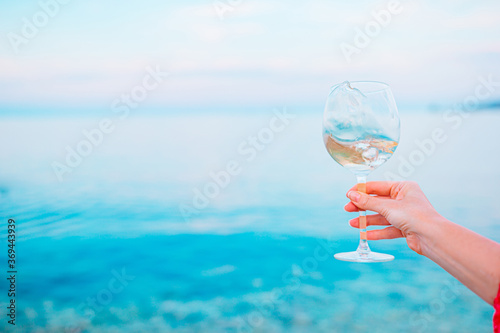 Glass of white wine on tropical beach