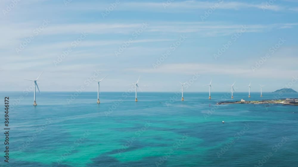 Wind turbines lined up over the sea. Sea and sky scenery. Jeju island. Wind turbines lined up over the sea. Sea and sky scenery. Jeju island.