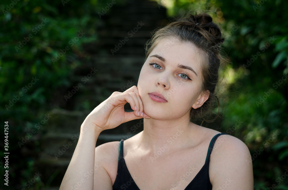 Portrait of a young beautiful girl with a thoughtful expression on her face