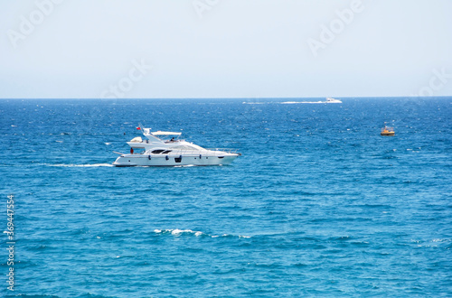 Antalya, Turkey, may 23, 2020. White motor yacht on the waves of the blue a sea © Mari