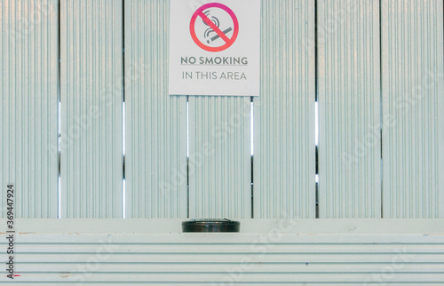 Iconic no smoking in this area sign with a contradictory ashtray beneath that warning  photo