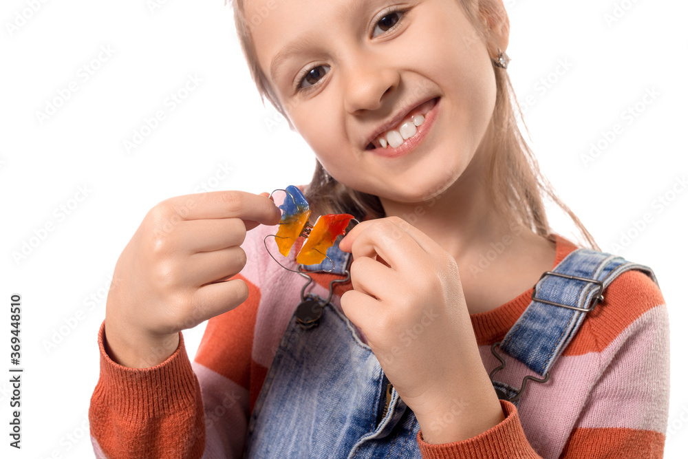 Little girl with orthodontics appliance isolated on white background. Little girl with orthodontics appliance isolated on white background.