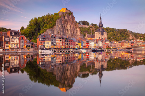 Obraz na płótnie Dinant, Belgium. Cityscape image of beautiful historical city of Dinant with the reflection of the city in the Meuse River at summer sunset. w salonie