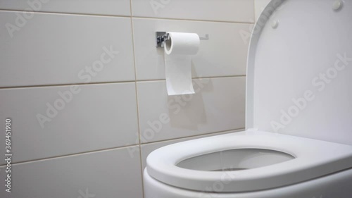Black-haired brunette teenager vomiting in white bathroom photo