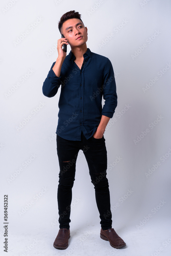 Portrait of young Asian businessman talking on the phone Portrait of young Asian businessman talking on the phone