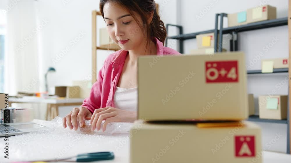 Young Asia entrepreneur businesswoman packing product in cardboard box deliver to customer, working at home office. Small business owner, start up online market delivery, lifestyle freelance concept. Young Asia entrepreneur businesswoman packing product in cardboard box deliver to customer, working at home office. Small business owner, start up online market delivery, lifestyle freelance concept.