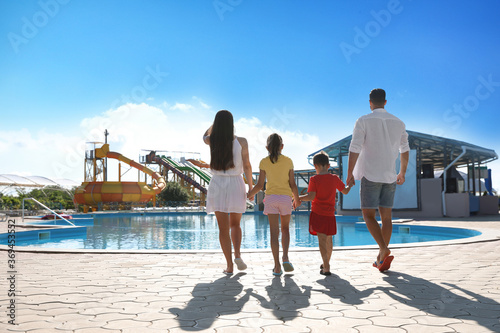 Family at water park  back view.  Summer vacation