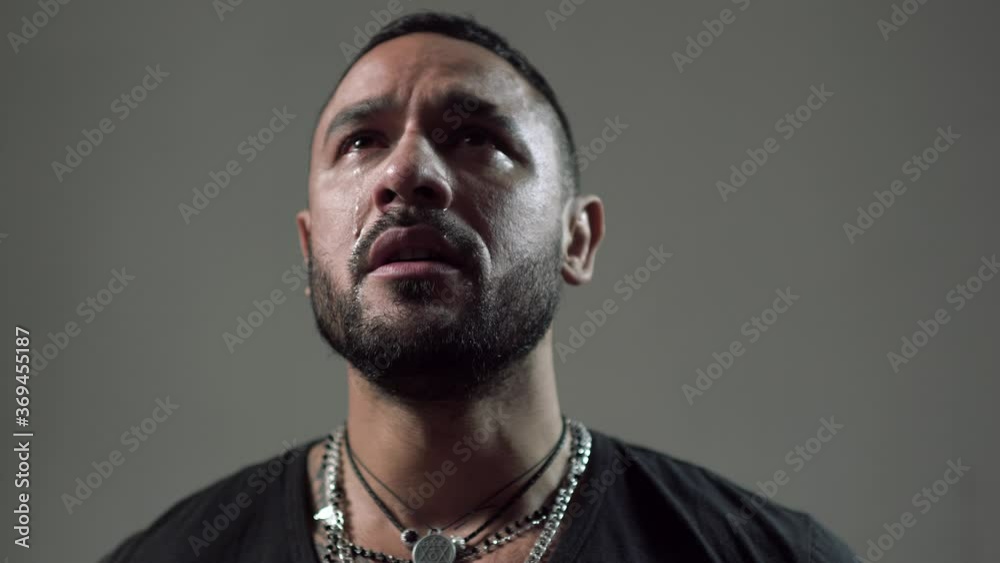 Crying man with tears on face closeup. Tears in eyes of crying adult man.