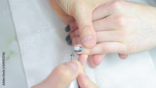the manicure master cuts off the gel Polish on the client's hands. High quality FullHD footage