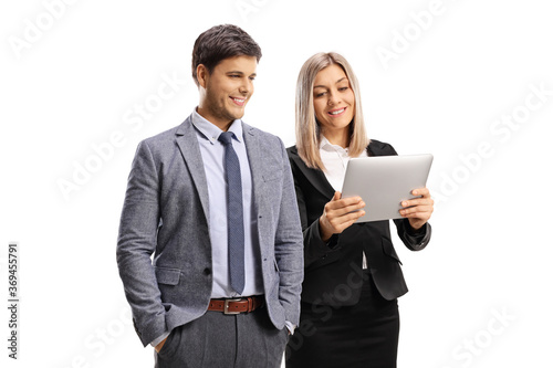 Professional young man and woman looking at a digital tablet