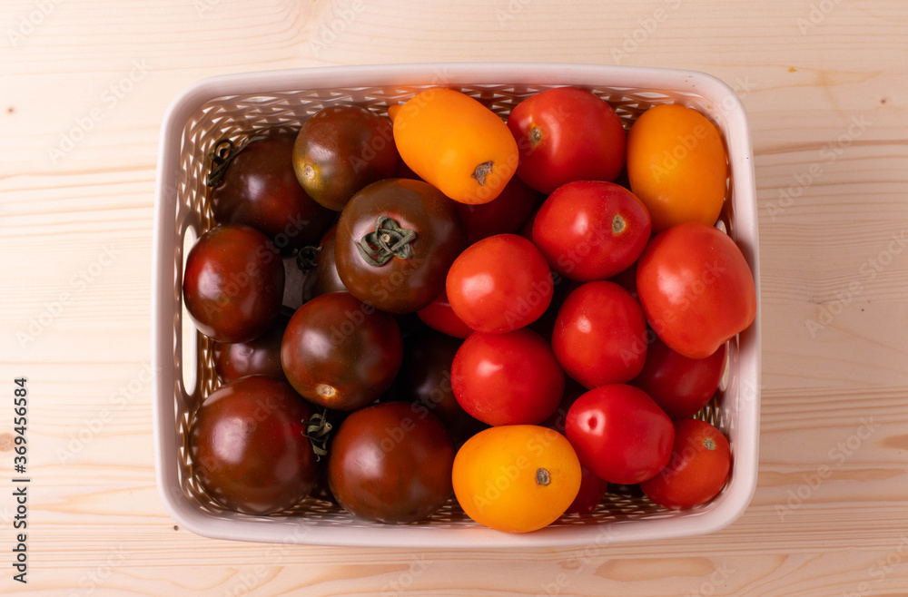 a group of tomatoes in a plastic container a group of tomatoes in a plastic container
