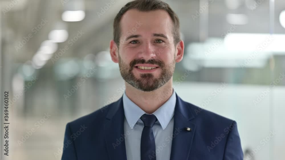 Portrait of Cheerful Businessman Waving at the Camera Portrait of Cheerful Businessman Waving at the Camera