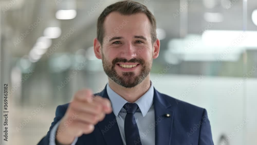 Portrait of Happy Businessman with Pointing with Finger Portrait of Happy Businessman with Pointing with Finger
