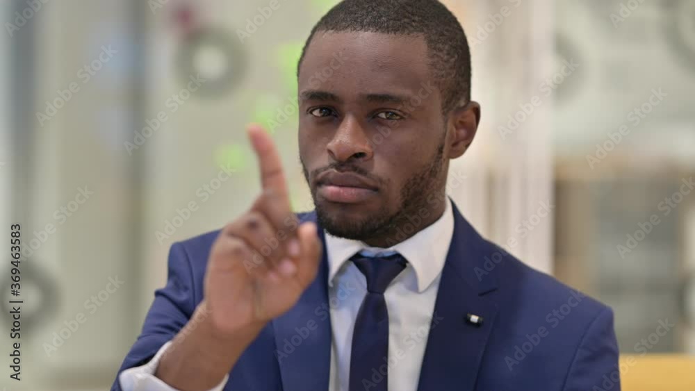 Portrait of African Businessman saying No by Finger