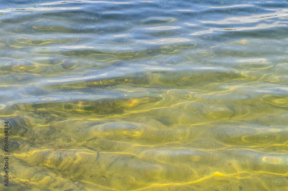 Beautiful sandy bottom of the lake. View through clear water Beautiful sandy bottom of the lake. View through clear water