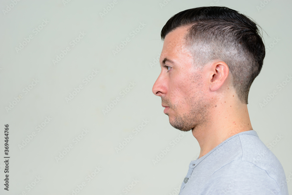 Profile view of young handsome man with beard stubble Profile view of young handsome man with beard stubble