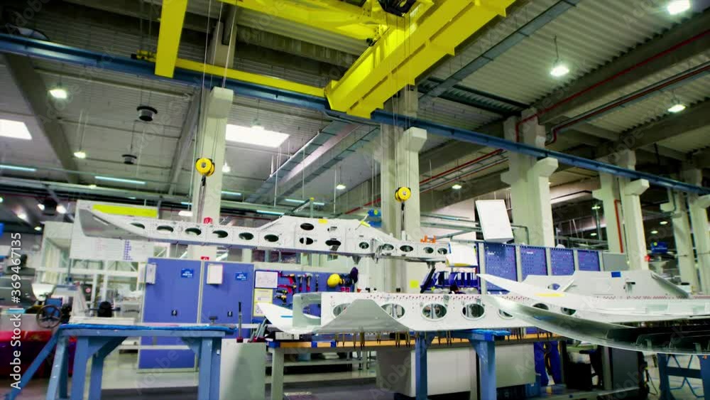 Overhead industrial crane moving inside an aircraft factory