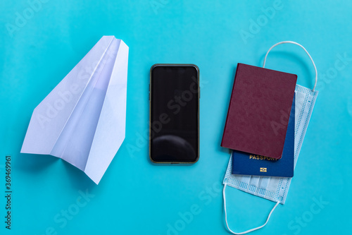Table top view accessory of accessory travel in holiday background concept. Flat lay of airplane with passport and protective mask. © Inception