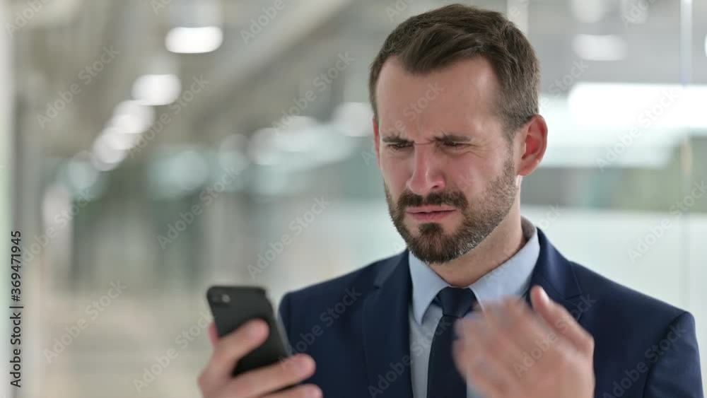 Portrait of Upset Businessman having Loss on Smartphone 