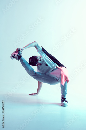 Stylish breakdancer guy dancing hip-hop in neon light. Dance school poster. Battle competition announcement © Georgii