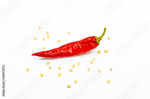 red chili pepper on a white background with seeds.