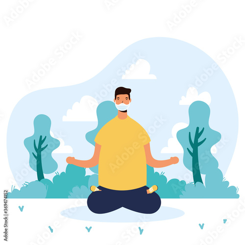 young man wearing medical mask practicing yoga