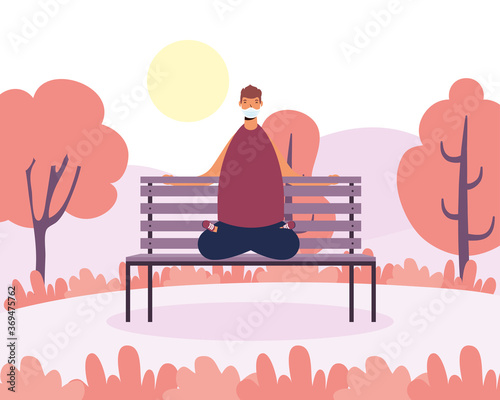 young man wearing medical mask practicing yoga in park chair
