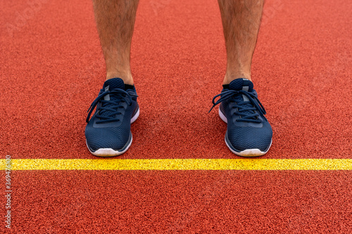 Man standing behind the yellow line in the sports ground