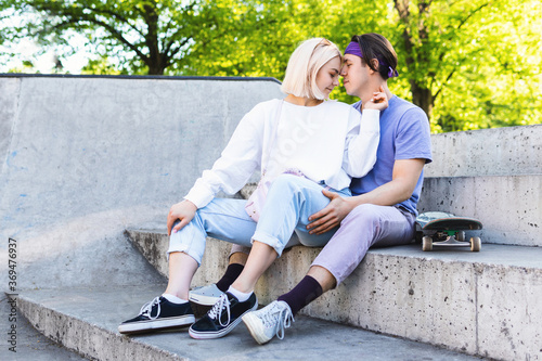 Sensual and loving teenager couple in a skate-park