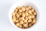 Top view of  cooked chickpeas in white bowl. Healthy food concept