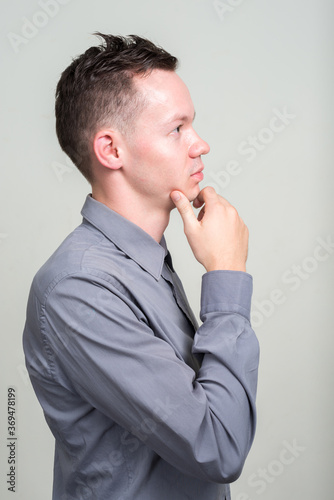 Portrait of young businessman against white background