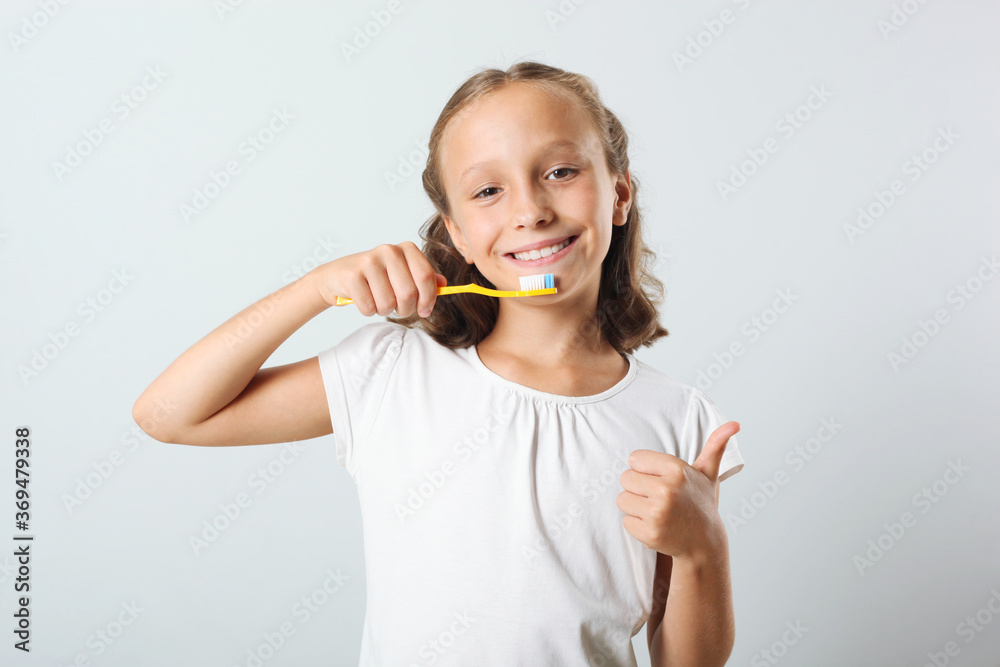 Little girl brushes her teeth in the bathroom. Dental care for children
Little girl brushes her teeth in the bathroom. Dental care for children