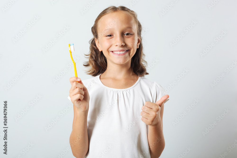 Little girl brushes her teeth in the bathroom. Dental care for children
Little girl brushes her teeth in the bathroom. Dental care for children