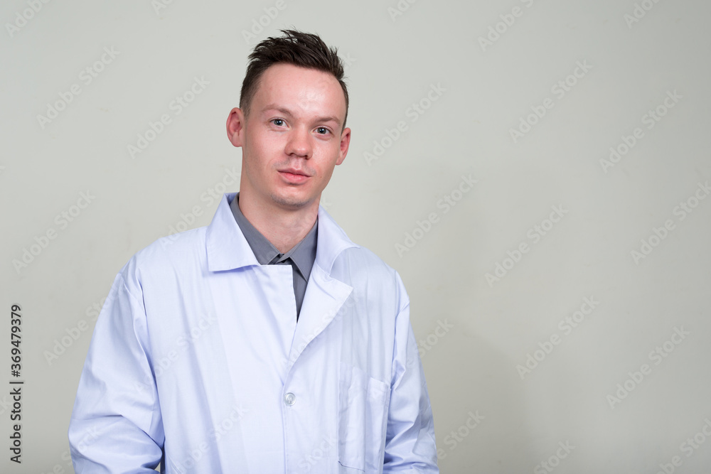 Portrait of young man doctor looking at camera Portrait of young man doctor looking at camera