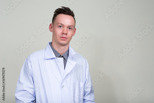 Portrait of young man doctor looking at camera