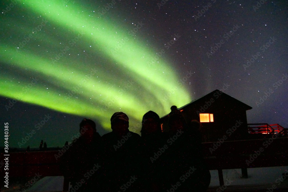 Silhouette of tourist  with norther light background in Fairbanks, Alaska