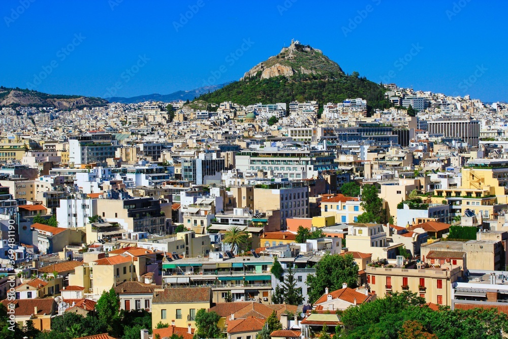 Greece, Athens, June 16 2020 - Athens city view from the area of Anafiotika in Plaka district with Lycabetus hill in the background.