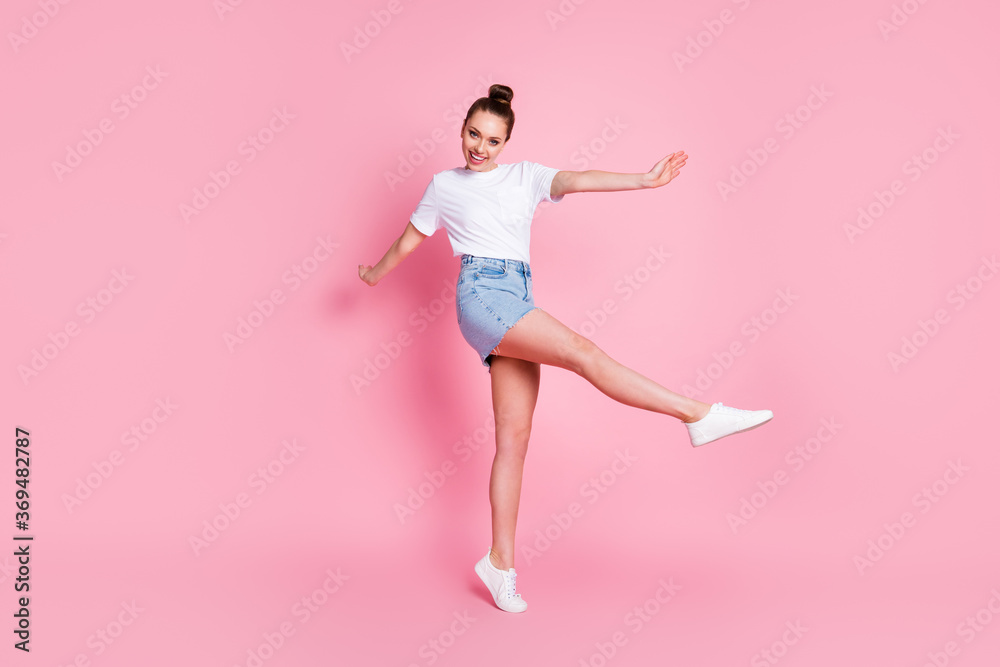 Full size photo of enthusiastic candid girl enjoy rejoice rest relax raise leg wear good look outfit gumshoes isolated over pink color background Full size photo of enthusiastic candid girl enjoy rejoice rest relax raise leg wear good look outfit gumshoes isolated over pink color background