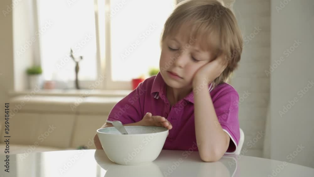 7 year old caucasian boy refuses to eat soup. Child hate soup. 7 year old caucasian boy refuses to eat soup. Child hate soup.