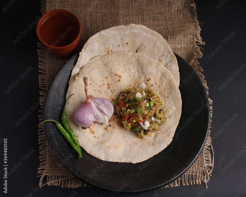 Baigan/Baingan Bharta Mashed roasted Eggplant cooked with spices & vegetables. Served with