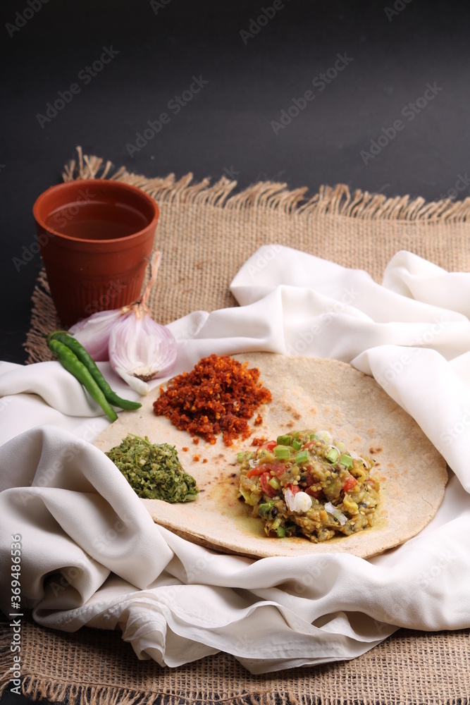 Baigan/Baingan Bharta Mashed roasted Eggplant cooked with spices & vegetables, crushed gree