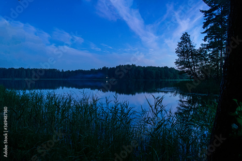 Peaceful night scene with the starry sky at a lake in Lithuania.