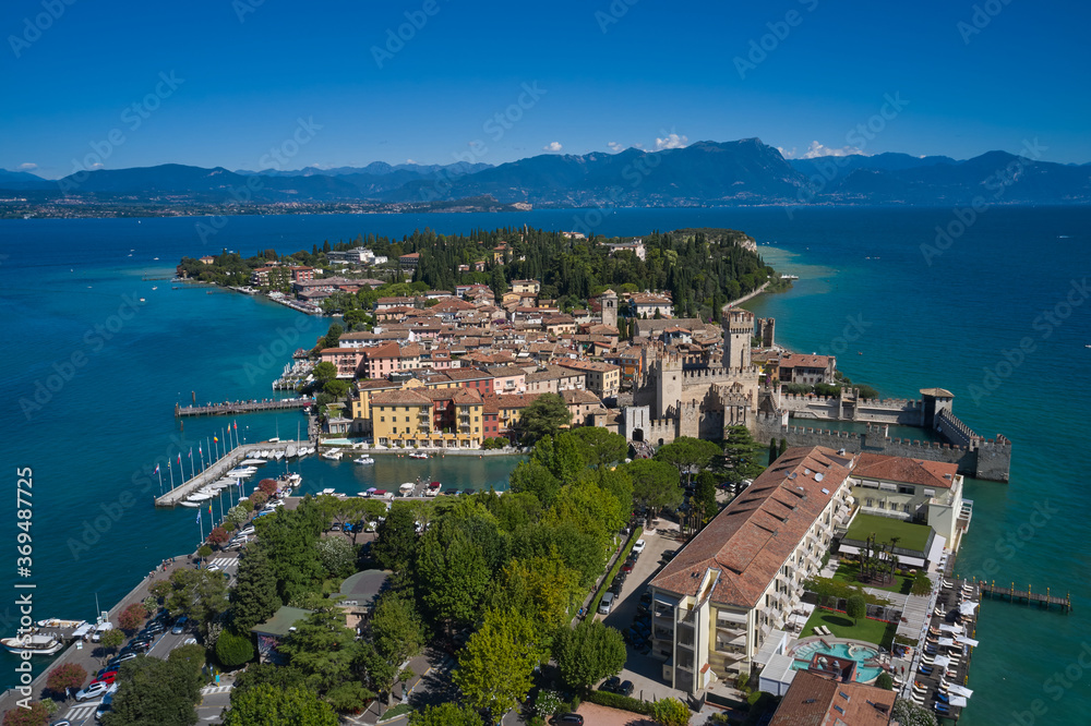 Rocca Scaligera Castle in Sirmione. Panoramic aerial view early in the morning, Sirmione, an ancient village on southern Garda Lake, Italy. View by Drone.