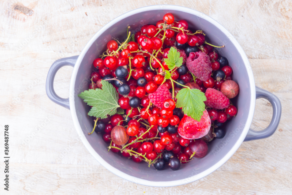 mixed berries in a bowl on wooden table mixed berries in a bowl on wooden table