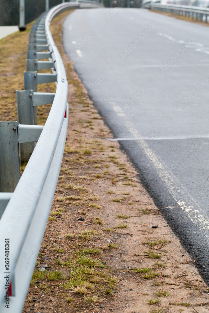 Metal guardrail mounted on a rural highway Metal guardrail mounted on a rural highway