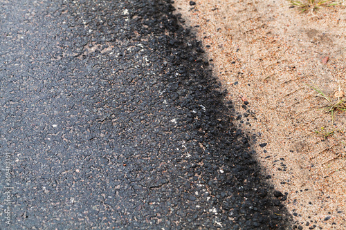 Rural asphalt road border and roadside