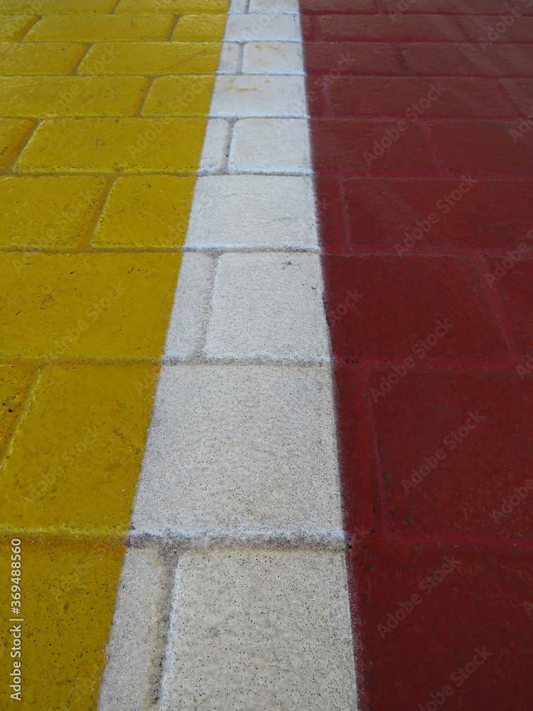 Background of red and yellow tiles separated by white line. Pattern and texture perspective view.
