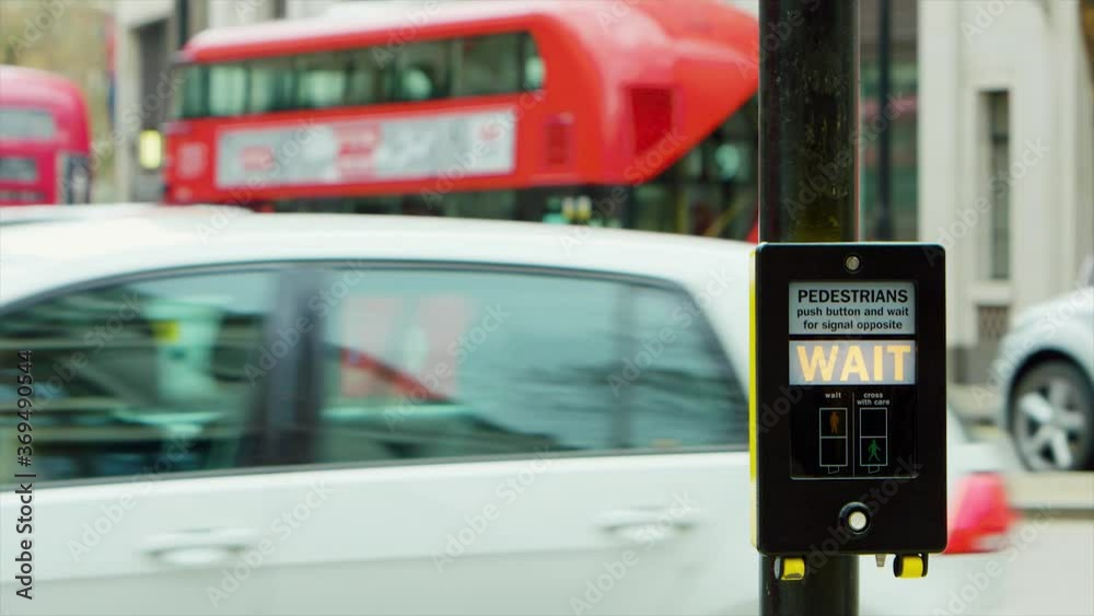 Walk or wait sign next to a crosswalk in London, UK. Warning signal, safety Walk or wait sign next to a crosswalk in London, UK. Warning signal, safety