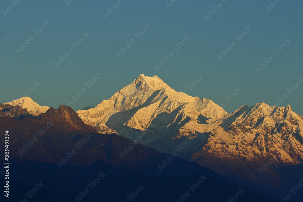 View of Mt Kanchenjunga with first rays of sunlight falling on it as seen from Hanuman top in Gantok Sikkim India